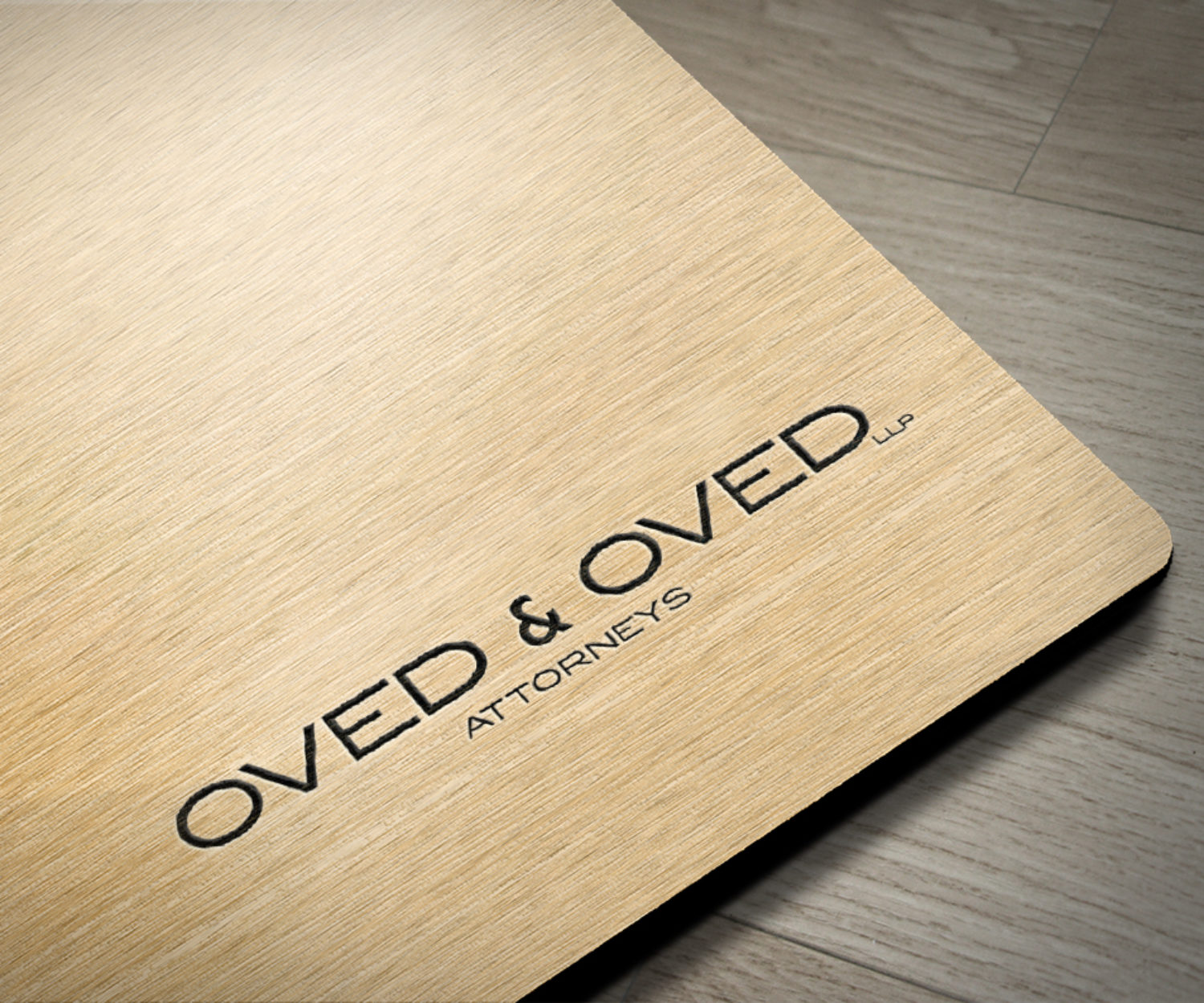 law firm logo design displayed on wood surface