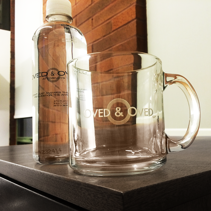 law firm logo design displayed on glass cup